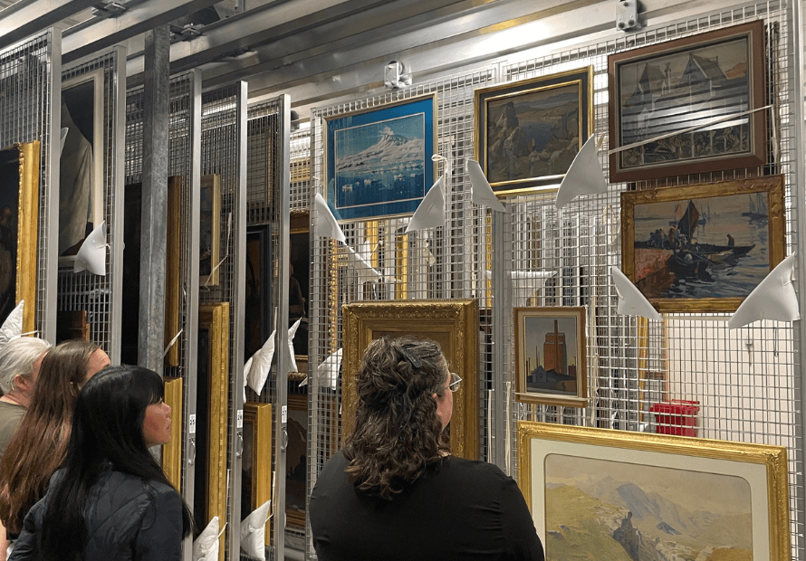 People gazing upon artworks in the storage room