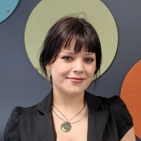 Fyfa Main smiling headshot. She has black hair that's tied up and has a fringe.