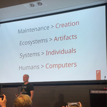 Justin Warren pictured speaking at Everything Open 2025. Behind him is a screen that displays ‘Maintenance &amp;amp;amp;amp;amp;amp;amp;amp;gt; Creation, Ecosystems &amp;amp;amp;amp;amp;amp;amp;amp;gt; Artifacts, Systems &amp;amp;amp;amp;amp;amp;amp;amp;gt; Individuals, Humans &amp;amp;amp;amp;amp;amp;amp;amp;gt; Computers.