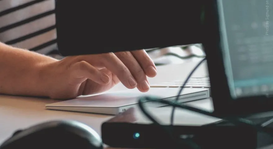 Close up of a persons hand typing