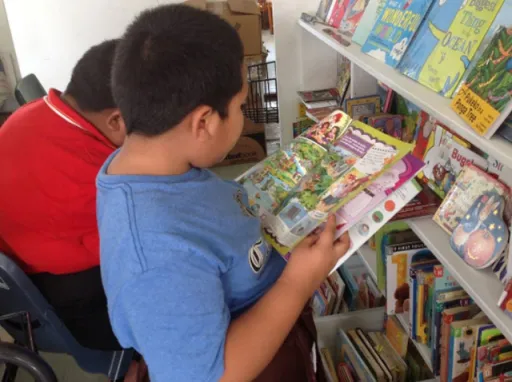 kids looking at books in a library