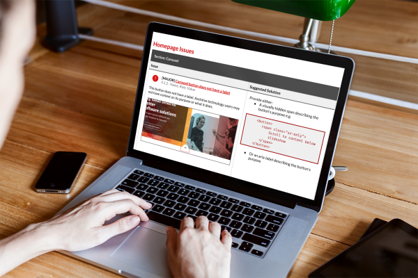 A laptop displaying a report displaying home page issues using an older version of the Catalyst site as an example. It identifies the issue with a screenshot and how to fix it in the code.