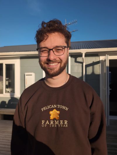 Smiling picture of Pedro Sawyer. He wears glasses and a brown jumper.