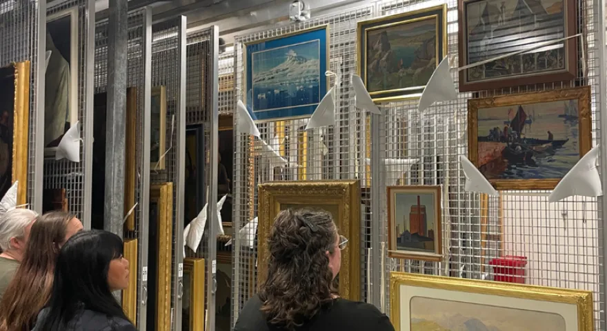 Gazing upon artworks in the storage room