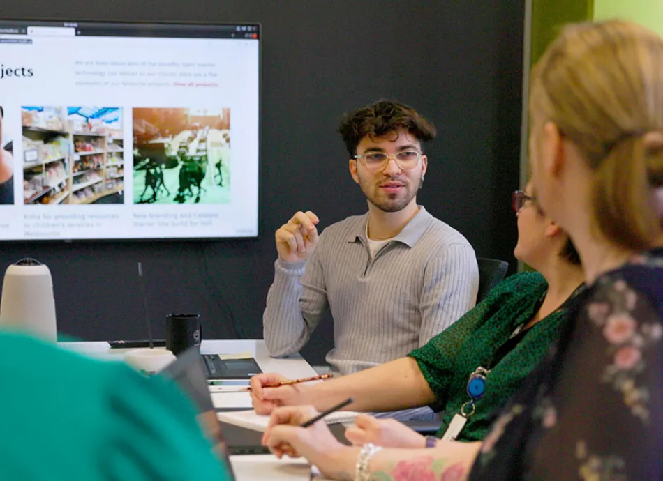 group in meeting looking at screen v2