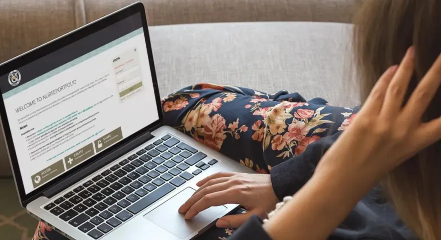 Woman using a laptop to navigate through the portfolio page on the College of Nurses Aotearoa website.