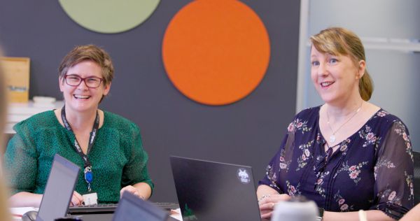Two women smiling.