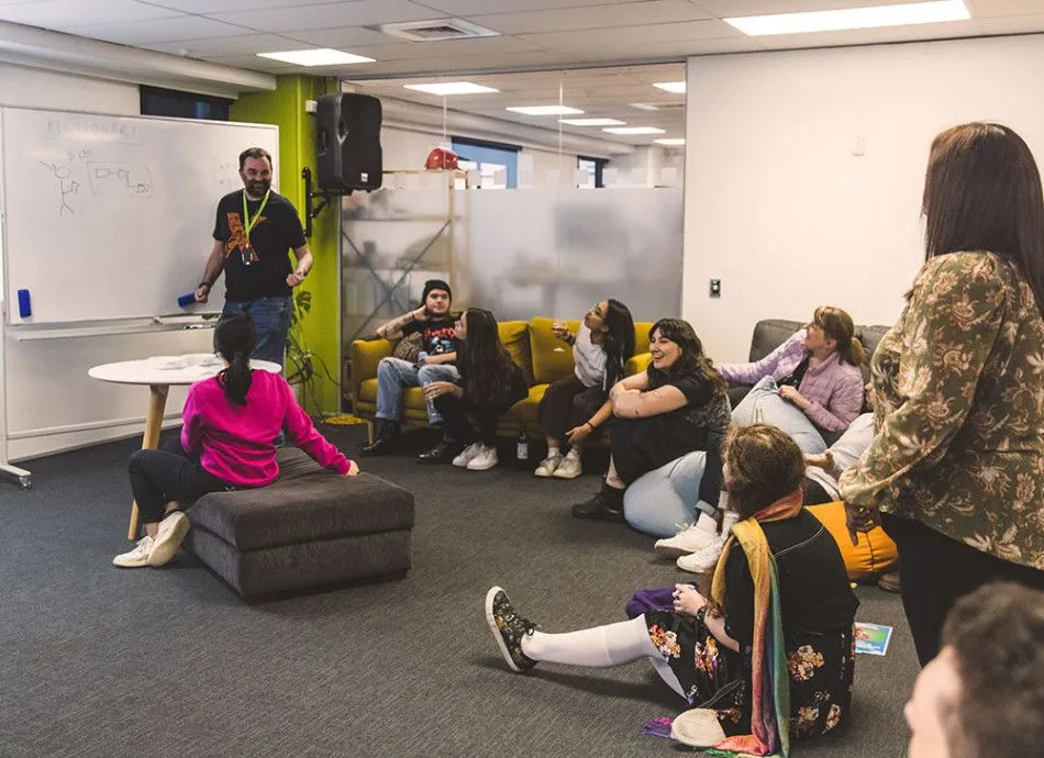 Catalyst employees sat in the office laughing
