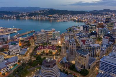 A birds eye view of Wellington, where you can see the harbour, the hills, the behive and the buildings in the CBD at night