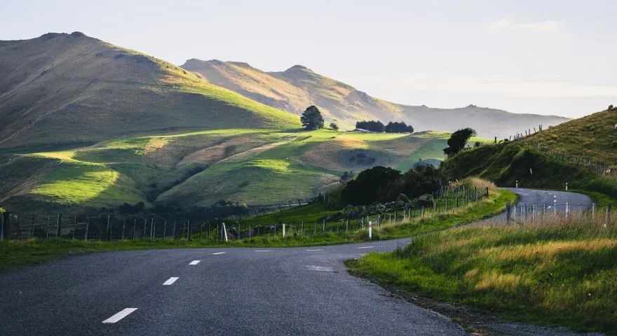 Picture of road winding around a hillside in New Zealand
